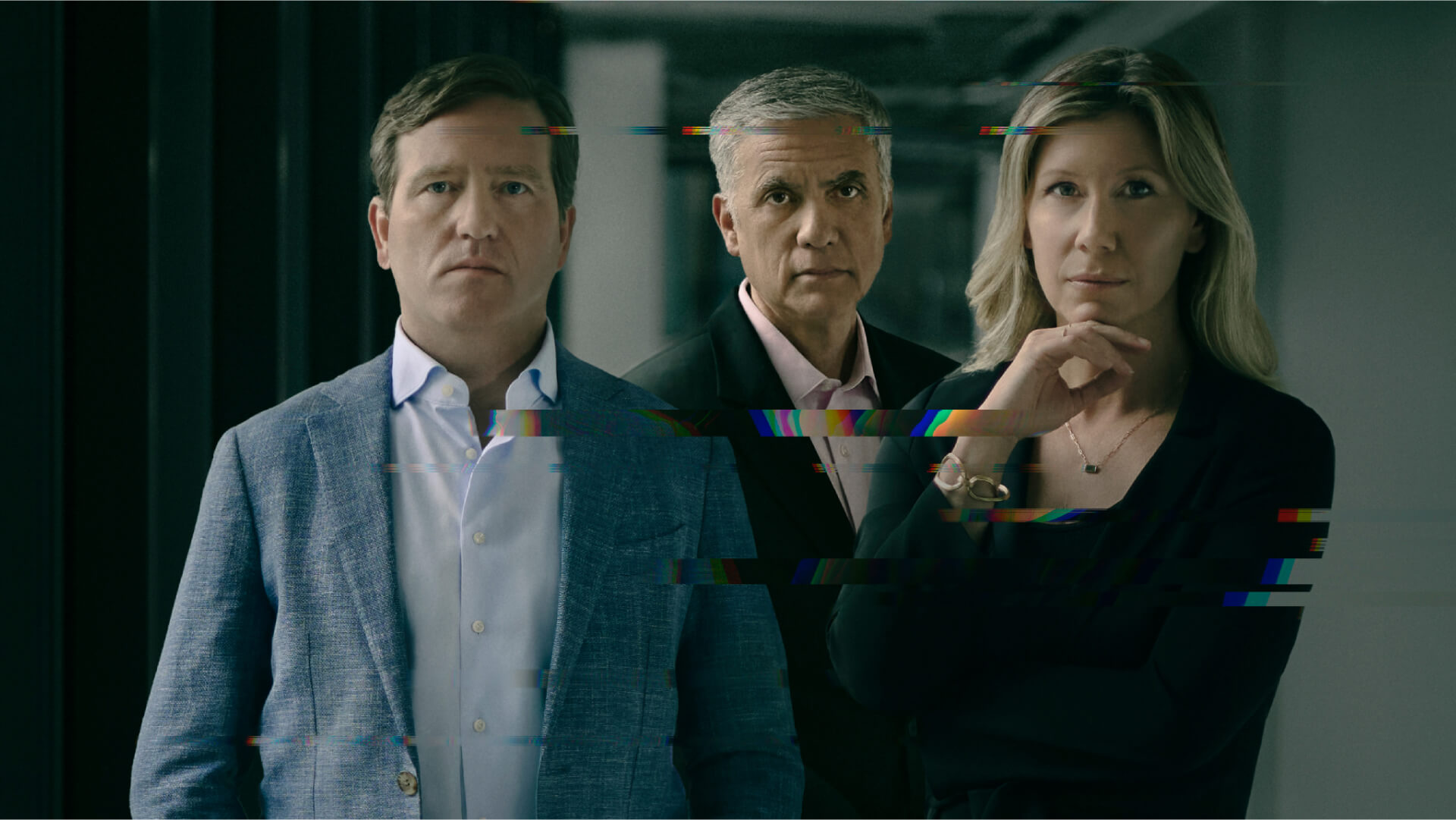 A composed portrait of three adults standing side by side in a dim corridor, looking directly at the camera, with horizontal glitch-like digital artifacts streaking across the image to suggest themes of cybersecurity and digital interference 